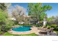 Backyard pool with natural stone surround and tanning deck at 4667 Ashfield Dr, Boulder, CO 80301