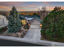 Beautiful home with a two-car garage and mature landscaping. Offers mountain views at sunset at 498 Eisenhower Dr, Louisville, CO 80027