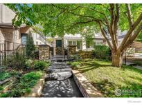 Inviting front yard with stone pathway, lush landscaping, and mature trees at 538 Madison St, Denver, CO 80206