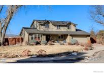 Two-story house with a brick facade, attached garage, and landscaping at 7913 Grasmere Dr, Boulder, CO 80301