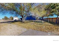 Ranch home with detached garage and fenced yard at 8233 Highway 66, Platteville, CO 80651