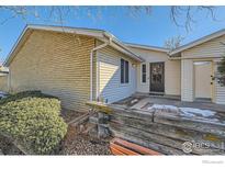 Ranch style home with light yellow brick and vinyl siding at 246 S 22Nd Ave, Brighton, CO 80601