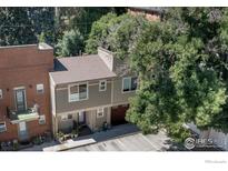 Aerial view of a modern townhouse with a brick facade and private parking at 409 Terry St # D, Longmont, CO 80501