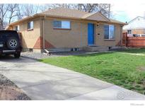 Ranch style home with a blue front door and a well-maintained lawn at 7779 Pecos St, Denver, CO 80221