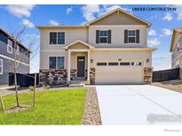 Two-story house with beige siding, gray shutters, and a two-car garage at 2243 Crosswind St, Fort Lupton, CO 80621