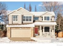 Two-story house with a beige exterior, double car garage, and landscaping at 4588 Pussy Willow Ct, Boulder, CO 80301