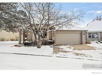 Brick ranch home with snow-covered yard and attached garage at 7329 Windsor Dr, Boulder, CO 80301