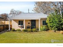 Charming single-story home featuring a cozy front porch with seating and a well-maintained lawn at 1171 Quebec St, Denver, CO 80220
