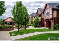 Attractive community courtyard with landscaping, walkway, and covered patio area at 1379 Charles Dr # 7, Longmont, CO 80503