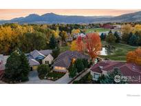 Breathtaking aerial view of a luxurious home nestled among colorful fall foliage with mountain views at 2500 Pampas Ct, Boulder, CO 80304