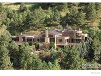 Luxury home nestled in a scenic mountainside setting with lush greenery at 45 Bellevue Dr, Boulder, CO 80302