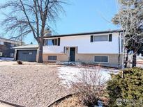 Ranch style home with a two-car garage and landscaped yard at 12802 E Nevada Cir, Aurora, CO 80012