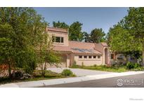 Tan stucco house with tile roof, attached garage, and landscaping at 1715 Sunset Blvd, Boulder, CO 80304