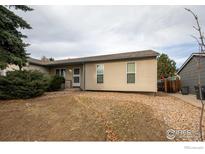 Tan exterior house with a small yard and landscaping at 209 Lucerne Way, Lafayette, CO 80026