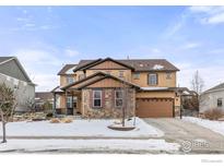 Two-story house with tan siding, brown accents, and a three-car garage at 2262 Madison Dr, Erie, CO 80516