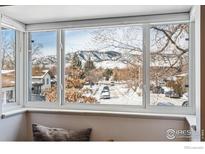 Stunning mountain views and snow-covered neighborhood seen from a bright window at 2663 Lloyd Cir, Boulder, CO 80304