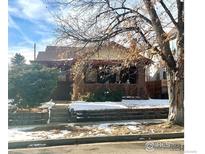 Brick home with a covered porch and landscaping at 3139 Benton St, Wheat Ridge, CO 80214