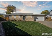 Ranch-style home with a brick facade, attached garage, and well-maintained lawn at 3146 W 134Th Ct, Broomfield, CO 80020