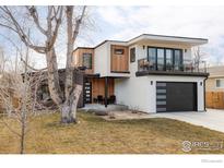 Contemporary home showcasing a balcony, modern garage door, and stylish wood and stucco facade at 3560 16Th St, Boulder, CO 80304