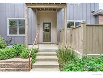 Inviting townhouse entry with stairs, landscaping, and a private fenced area at 4137 Clifton Ct # C, Boulder, CO 80301