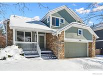 Two-story house with stone and siding exterior, snowy front yard, and attached garage at 4856 10Th St, Boulder, CO 80304