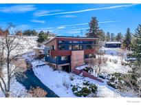 Modern home with mountain views, snowy landscape, and large yard at 512 Ponderosa Dr, Boulder, CO 80303