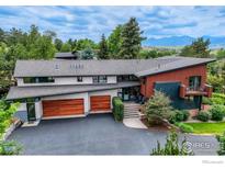 Stunning modern home with a unique roof design, wood accents, two-car garage, and mountain views at 512 Ponderosa Dr, Boulder, CO 80303