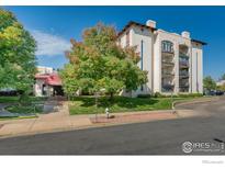 Spanish-style condo building with landscaping and a gated entrance at 805 29Th St # 252, Boulder, CO 80303