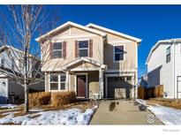 Two-story house with attached garage and landscaping at 10685 Forester Pl, Longmont, CO 80504