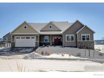 Two-story craftsman style home with a large front yard and attached garage at 1393 Sara Lynn Ln, Berthoud, CO 80513