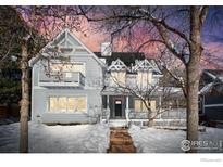 Two-story house with gray siding, snowy front yard, and walkway at 1465 Periwinkle Dr, Boulder, CO 80304