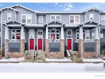 Three-unit townhome building with red doors and snow-covered front yards at 1580 Venice Ln, Longmont, CO 80503