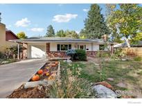 Brick ranch house with a well-manicured lawn and garden at 1855 Grape Ave, Boulder, CO 80304