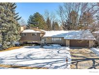 Ranch style home with snow covered yard and attached garage at 350 Hopi Pl, Boulder, CO 80303