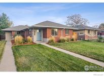 Brick ranch home with landscaped lawn and walkway at 3608 Grape St, Denver, CO 80207