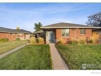 Brick ranch home with landscaped yard and walkway at 3608 Grape St, Denver, CO 80207