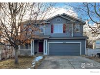 Charming two-story home with gray siding, red shutters, and an attached two-car garage at 4329 San Marco Dr, Longmont, CO 80503