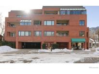 Brick building exterior with snow-covered parking lot at 624 Pearl St # 404, Boulder, CO 80302