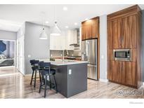 Modern kitchen with stainless steel appliances and an island at 11278 Colony Cir, Broomfield, CO 80021