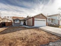 Charming single-story home with a well-maintained lawn and attached two-car garage at 1980 W 132Nd Ave, Denver, CO 80234