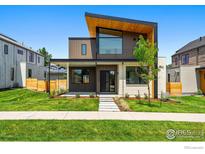 Stunning modern home with eye-catching architecture, manicured lawn, and inviting walkway at 2125 Vine Ave, Boulder, CO 80304