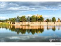 Vista Ridge community entrance with pond and landscaping at 3000 Blue Sky Cir # 108, Erie, CO 80516