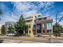 Modern brick building exterior with balconies and landscaping at 1655 Walnut St # 309, Boulder, CO 80302