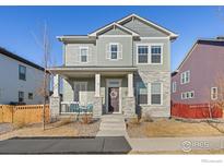 Charming two-story home with stone accents and a welcoming front porch at 21463 E 59Th Pl, Aurora, CO 80019