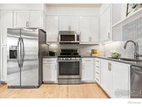 Modern kitchen with stainless steel appliances and white cabinetry at 3401 Arapahoe Ave # 102, Boulder, CO 80303