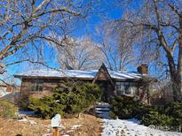 Brick ranch home with attached garage and mature trees at 4580 Garland St, Wheat Ridge, CO 80033