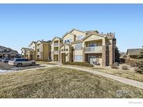 Apartment building exterior, showing landscaping and parking at 5756 N Genoa Way # 205, Aurora, CO 80019