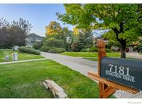 Landscaped front yard with mailbox and long driveway leading to a two-story house at 7181 Longview Dr, Niwot, CO 80503