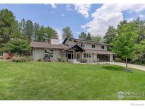 Charming two-story home featuring a well-manicured front yard, elegant entrance, and attached garage at 7332 Island Cir, Boulder, CO 80301