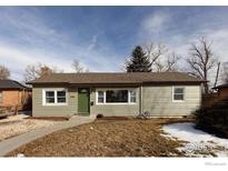 Charming ranch home with a green exterior, landscaping, and walkway at 1148 Gay St, Longmont, CO 80501